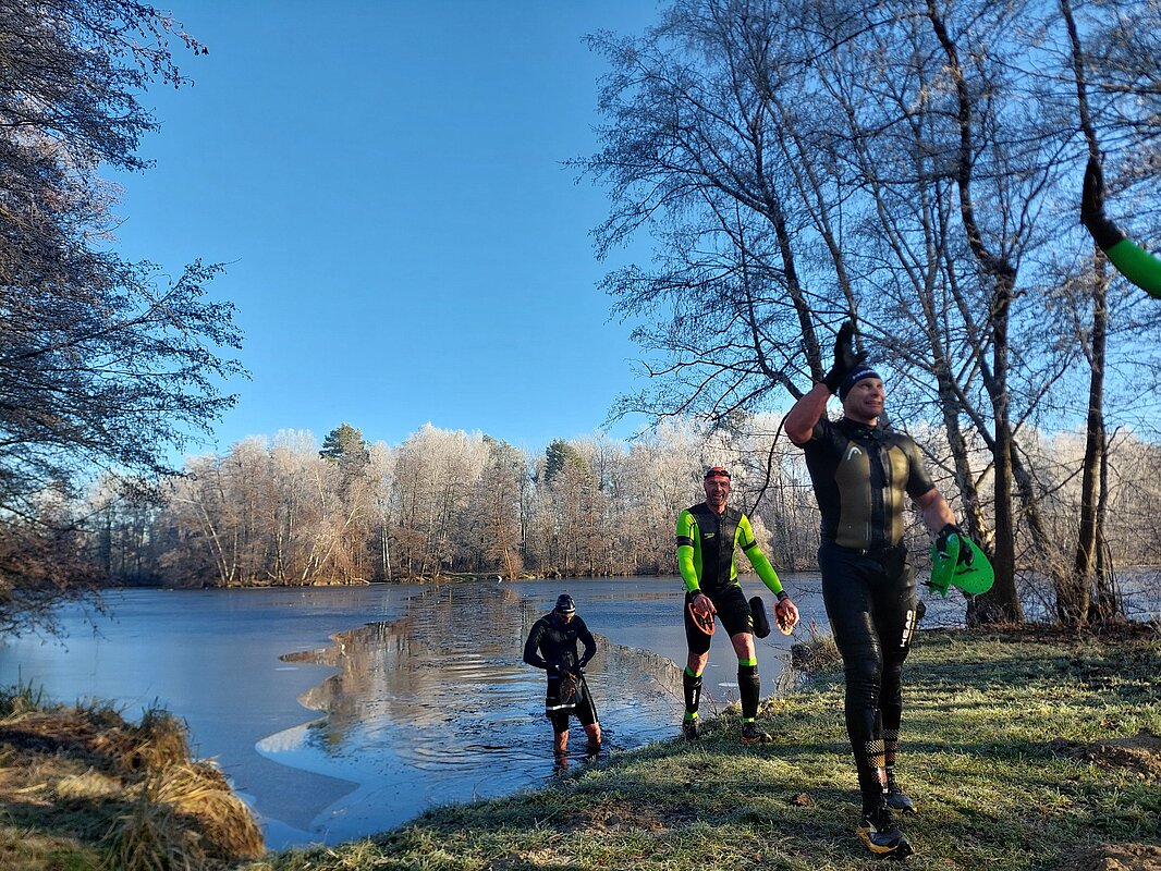 Image of three participants coming out of the river