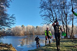 Image of three participants coming out of the river